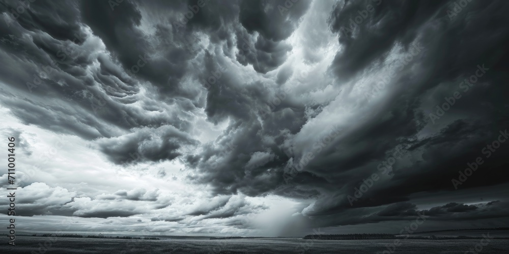 Poster a black and white photo capturing the beauty of a cloudy sky. suitable for various uses