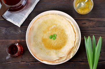 round thin pancakes with maple syrup on the table flat lay - obrazy, fototapety, plakaty