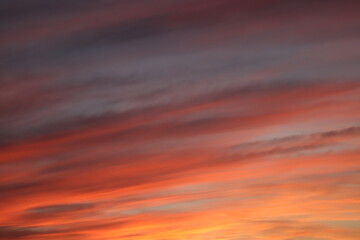 A breathtaking sunset sky painted with a palette of deep reds and oranges, a dramatic backdrop that evokes a sense of calm and wonder.