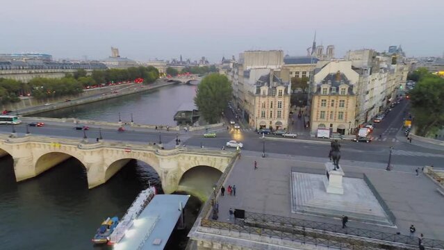 City traffic on Pont Neuf near Equestrian statue of King Henri IV