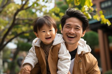 Happy Asian Father Carrying His Son on His Back
