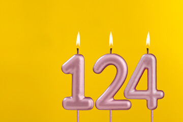 Birthday candle number 124 - Birthday celebration on yellow background
