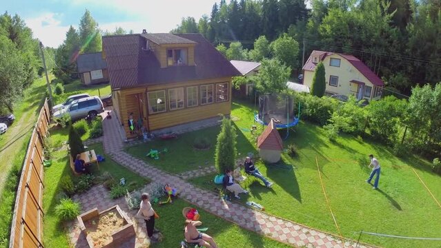 Ten members family get rest and play badminton on yard