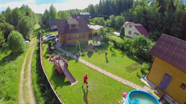 Family members get rest and play badminton on yard 
