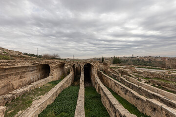 Fototapeta na wymiar Dara Ancient City. Dara aqueducts, tare cisterns. Ancient Water Channels in the Ancient City of Dara in Mardin, Turkey.