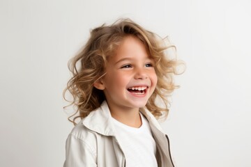 Portrait of a beautiful little girl with blond curly hair on a white background