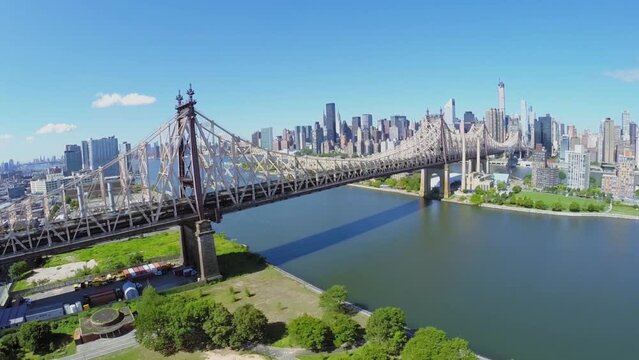 Cars ride by Queens Bridge over East River and Roosevelt Island