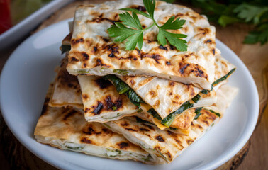 Traditional Turkish food, Turkish pancake gozleme with cheese and herb. The appetizer is Turkish pastry. There are varieties such as cheese, spinach, potato