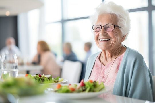 Happy elderly woman eating salad in a restaurant
