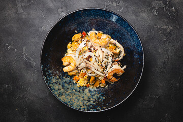 Fried rice with seafood, squid and tiger prawns. Food photography, restaurant, menu.