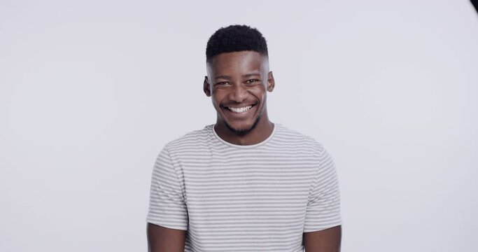 Happy, laughing and face of black man on a white background with excited smile, confidence and laughter. Emoji, fashion and portrait of isolated person for funny joke, comedy and humor in studio