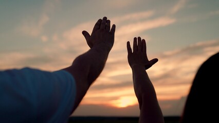 Man and woman raise their hands to sunny sky. Religion and faith teamwork. Man woman couple...