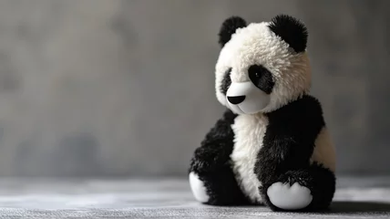 Poster Im Rahmen Close-up of a plush panda toy sitting on a textured surface © Artyom
