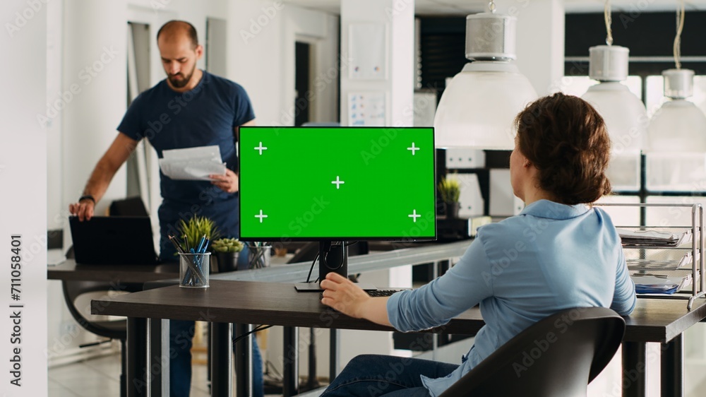 Poster specialist looking at greenscreen template on desktop monitor in small business agency workplace. pe