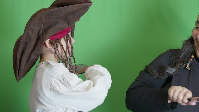 Pirates getting angry and fighting with cutlasses. Isolated on green background, slow motion. High quality 4k footage