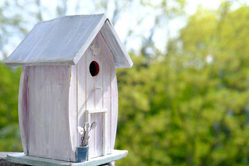 white painted birdhouse is ready for the new spring season, a house against the background of...