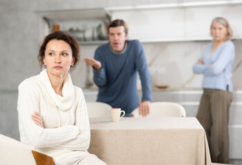 Fototapeta premium Man scolds woman and old woman stands nearby and looks at it. High quality photo