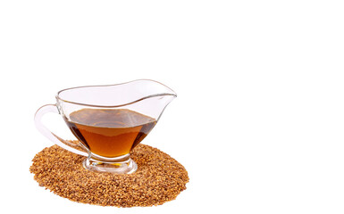 Bottle of sesame oil and sesame seeds isolated