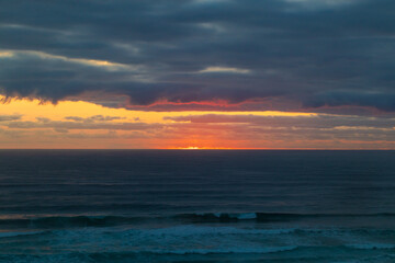 Fototapeta premium A Golden Dawn Breaks Over Gold Coast’s Tranquil Sea