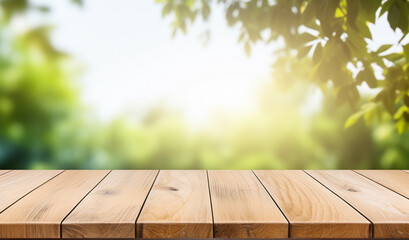Empty wooden deck table on the blurred summer trees background. Backdrop for mockup and promotion design.