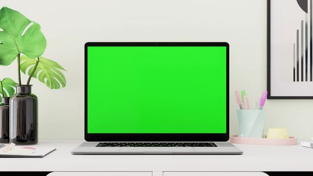 Close up shot of laptop on the desk with green screen chroma key, 4k slow motion