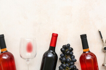 Glass and bottles of exquisite wine with grapes on white background