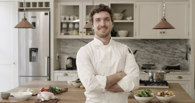 Crossed arms, smile and face of chef in kitchen for cooking at modern home or house. Happy, confidence and portrait of private male culinary artist with positive attitude for preparing meal or dinner