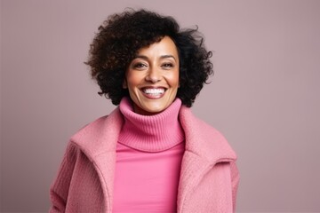 Portrait of a smiling african american woman in pink coat - obrazy, fototapety, plakaty
