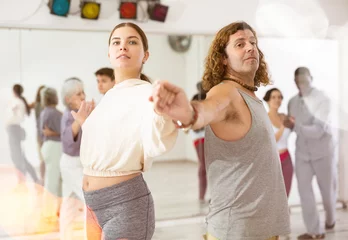 Foto op Plexiglas Dansschool Caucasian man and lady rehearsing latin paired dance moves