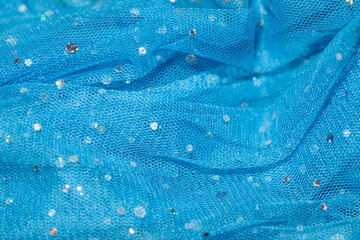 tissus bleu en tulle avec des petites et des grandes paillettes