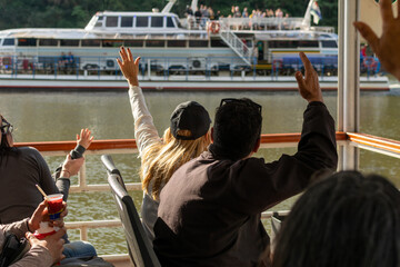 tuor on boat with people greeting other tourists