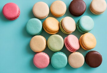 Top view of colorful cake macarons or macaroons on a turquoise background, pastel almond cookies, vintage card aesthetic