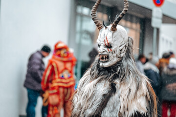 Carnival processions in Germany.Carnival costumes and characters. Krampus monster costumes on street background.Winter costume processions on the streets of Europe.Traditional cultural folklore - obrazy, fototapety, plakaty