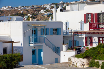 Streetview of Mykonos town with white street and blue door, Greece - 711115015