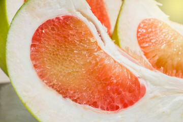 closeup, sliced ​​red pomelo fruit, on the table