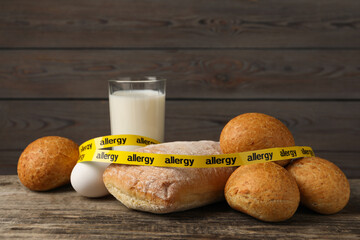 Allergenic food. Different fresh products with tape on wooden table