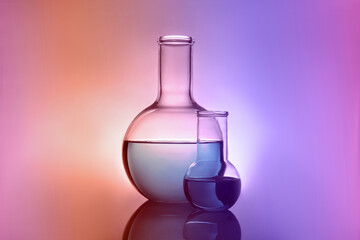 Flasks with liquid on table. Color toned