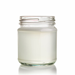 A crystal clear glass jar of organic coconut oil isolated on a white background 