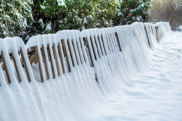 Wooden snow barriers in the park on a winter day.