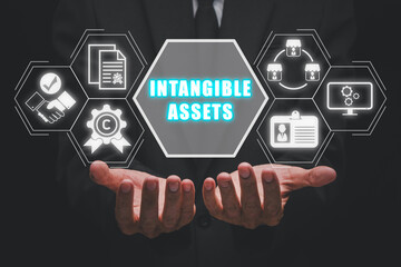 Intangible asset concept, Businessman hands holding intangible asset icon on virtual screen.