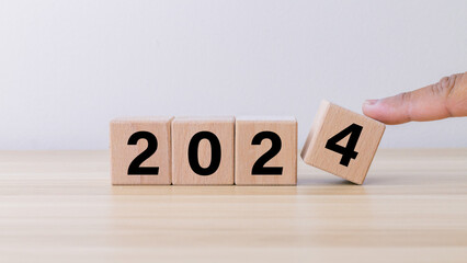 wooden cube block with 2024 text on wooden background.