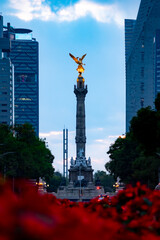 Amazing view of The Angel of Independence statue located among modern skyscrapers in Mexico city on...