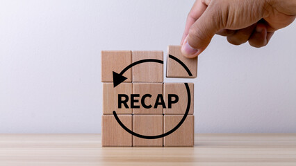 Recap economy, business, financial concept. For business planning. RECAP word icon on wooden cubes...