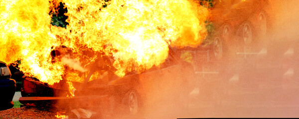 Firefighter Rescue training in fire fighting extinguisher. Firefighter fighting with flame using...