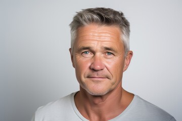Portrait of a senior man with grey hair and grey eyes.