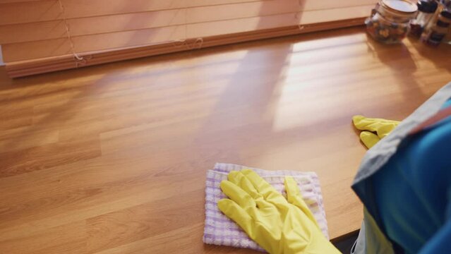 Close up hands of cleaning service woman worker clean kitchen at home. 