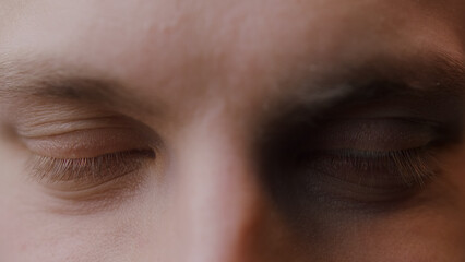 Extreme close-up closed eyes of young blonde man 
