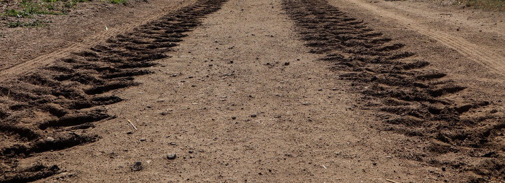 Tractor Tire Tracks In The Dirt. Dirt Texture
