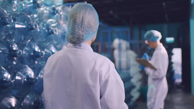 Caucasian female scientist working in laboratory at factory warehouse. 