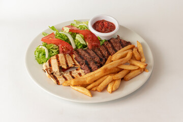 Chicken and french fries with salad